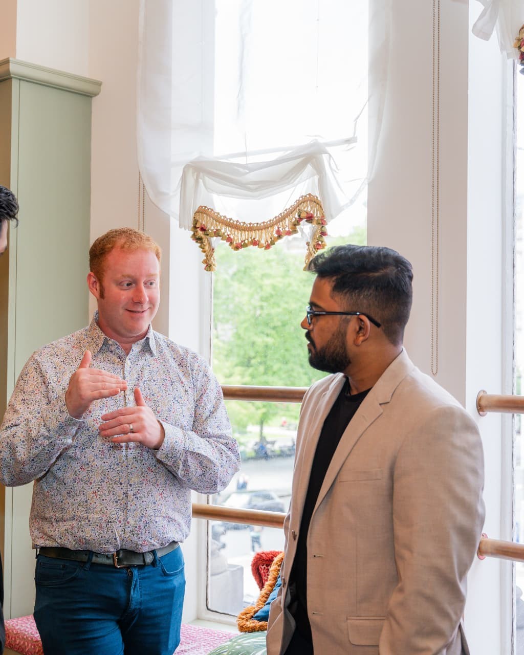 Tony McBride speaking with a client at an event